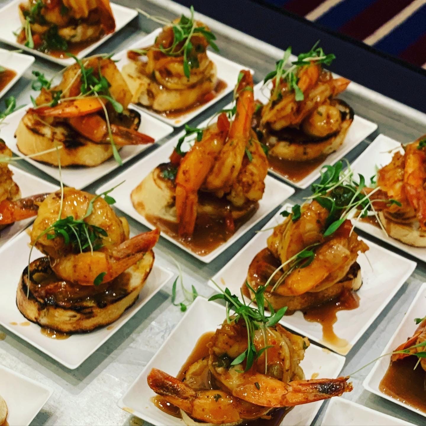 Gulf shrimp bruschetta canapés on a tray — perfect for private dinner parties