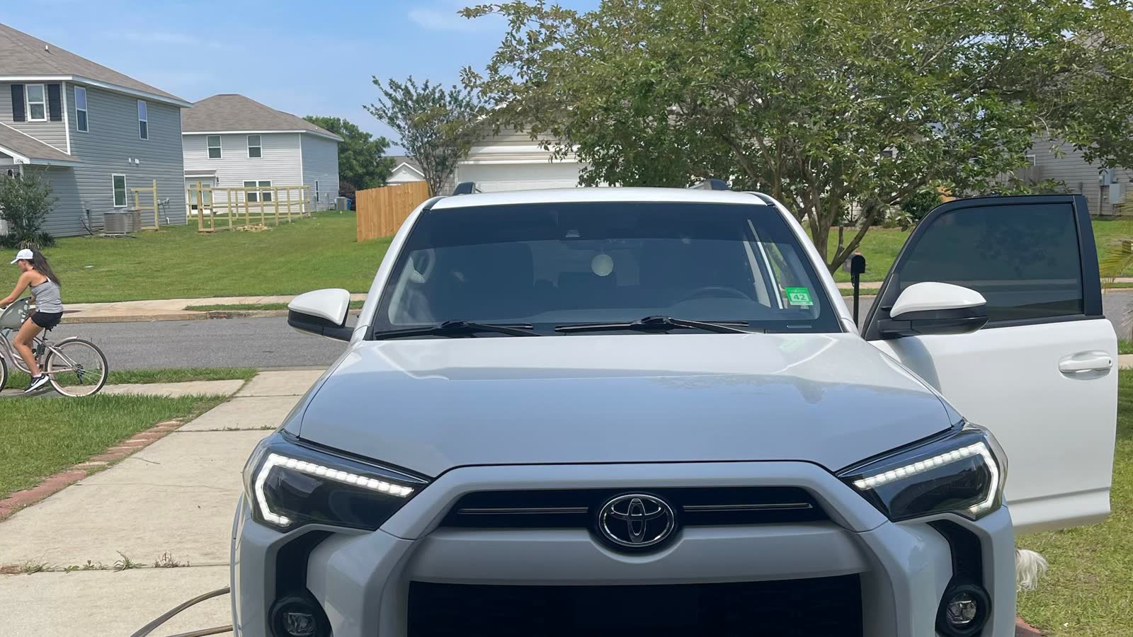 White 2021 Toyota 4Runner SR5 — front straight-on view, driveway