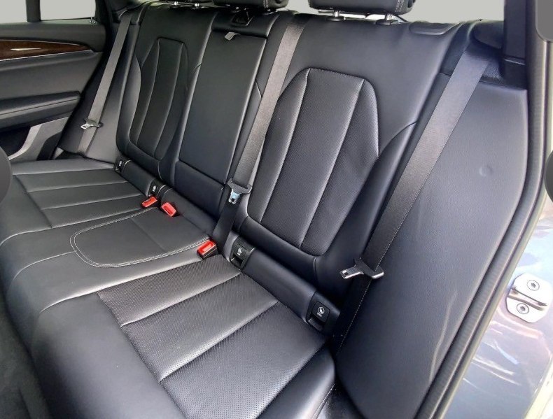 BMW X3 rear leather seating — black leather with white contrast stitching